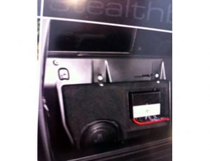 Jl audio stealth box with Jl amplifier behind the seat of a Toyota truck.